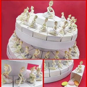 Torta portaconfetti ballerina realizzata con fette in cartoncino rigido. Le statuette in resina sono applicate su ogni singola fetta della torta.